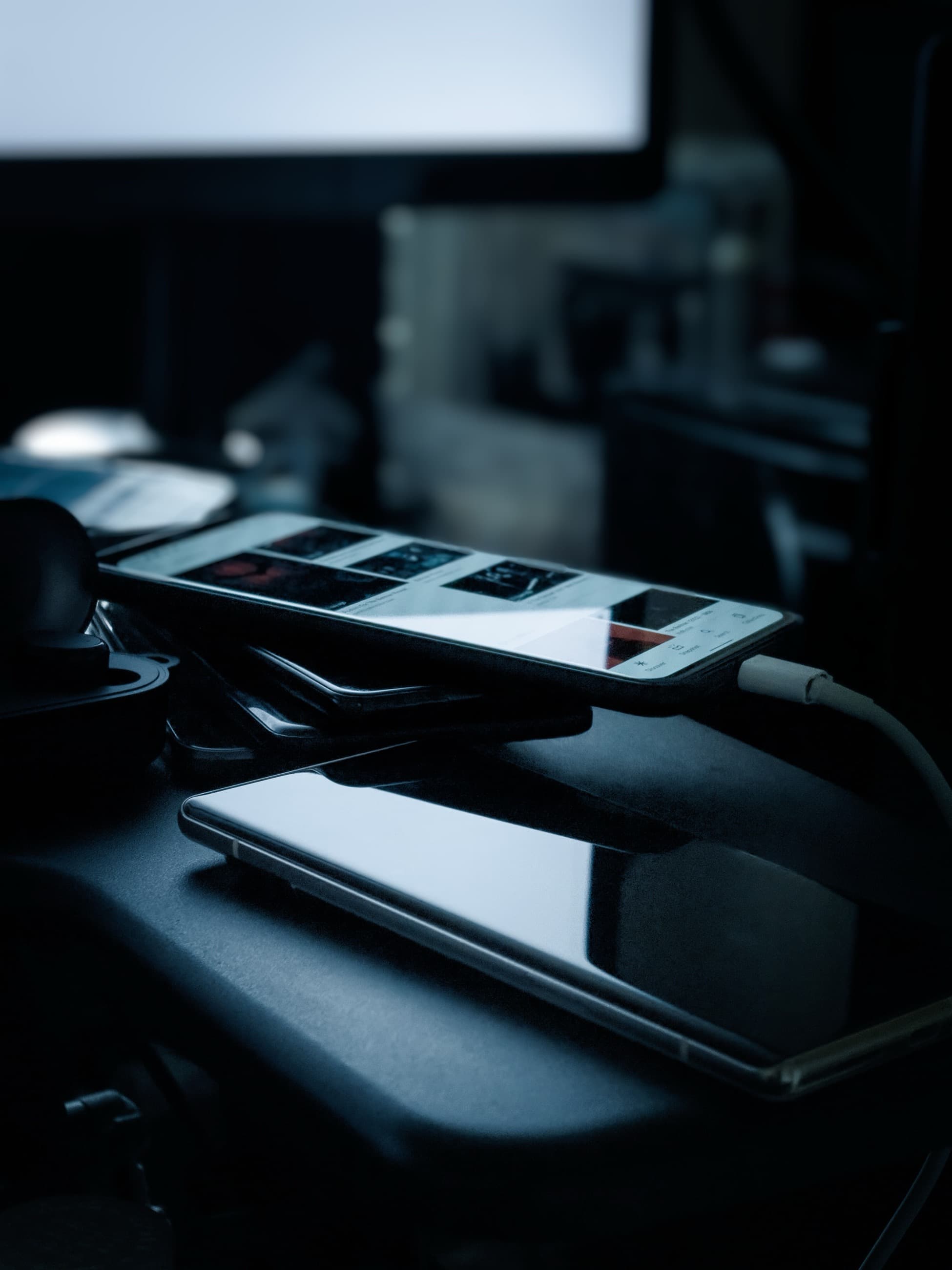 Phones charging on a desk